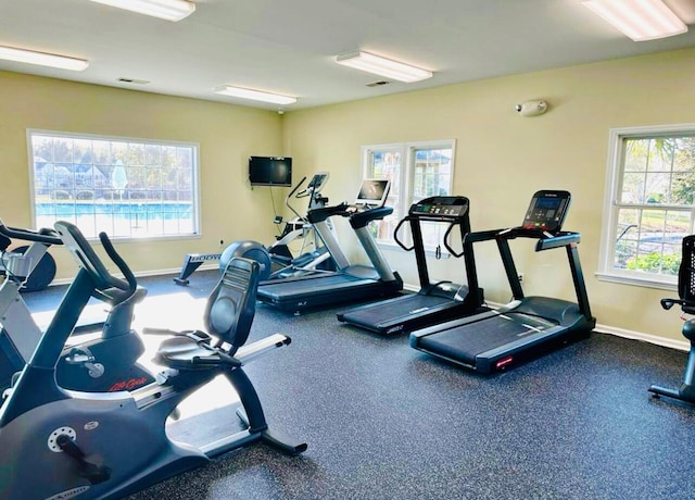 exercise room featuring visible vents and baseboards