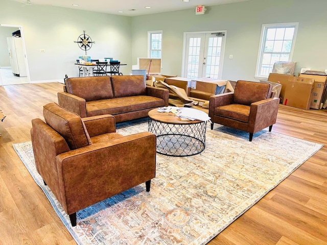 living area featuring recessed lighting, french doors, baseboards, and wood finished floors