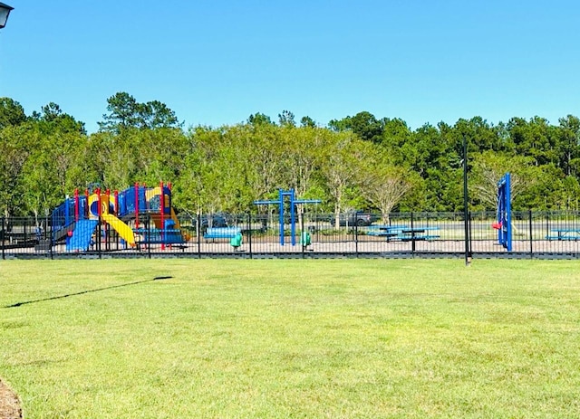 communal playground with a yard and fence