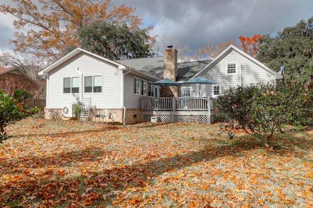 rear view of house featuring ac unit and a wooden deck