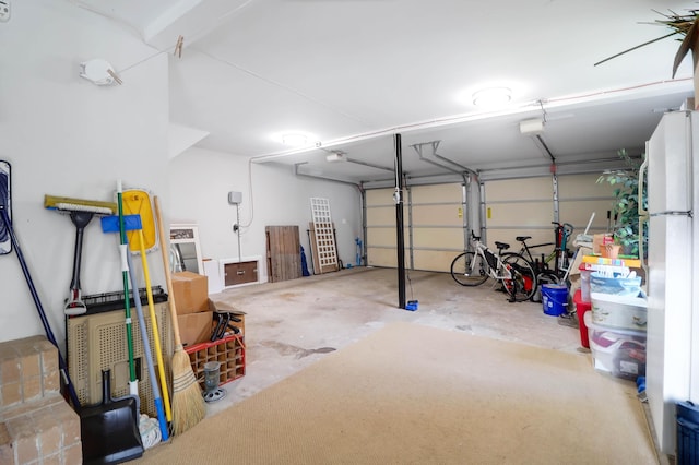 garage featuring a garage door opener and white refrigerator