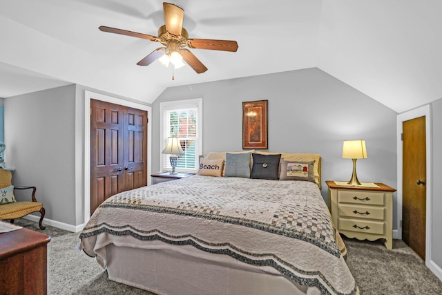 carpeted bedroom with ceiling fan, a closet, and vaulted ceiling