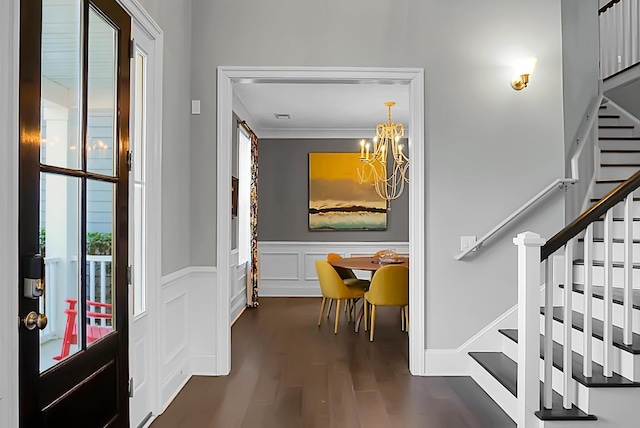 foyer featuring dark wood-type flooring and a notable chandelier