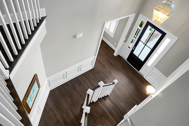 entryway featuring dark hardwood / wood-style flooring, a high ceiling, and an inviting chandelier