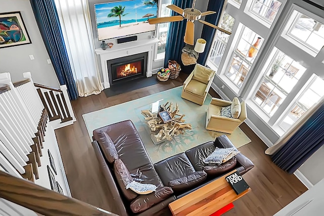 living room featuring ceiling fan and hardwood / wood-style floors