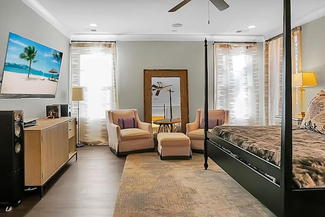 bedroom featuring multiple windows, wood-type flooring, ceiling fan, and crown molding