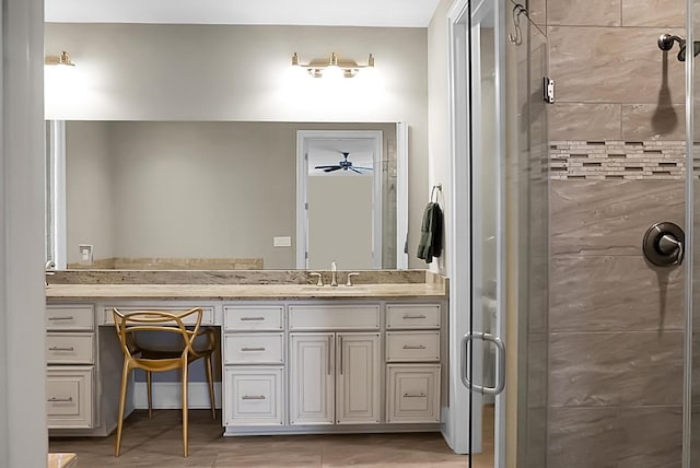 bathroom with ceiling fan, vanity, and a shower with shower door