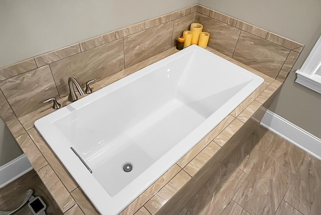 bathroom with a tub to relax in