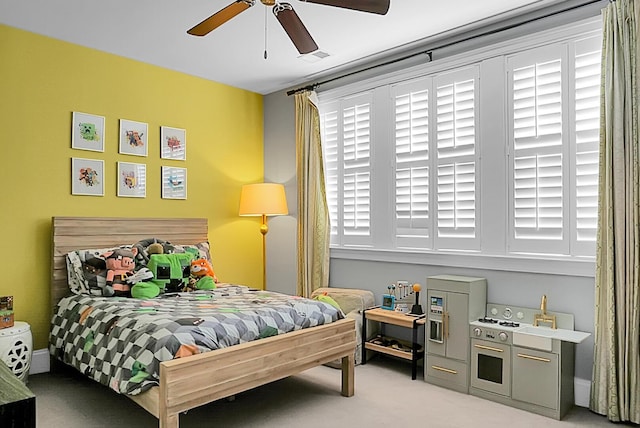 bedroom with ceiling fan and light carpet