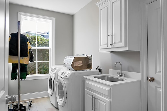 washroom featuring cabinets, separate washer and dryer, sink, and light wood-type flooring