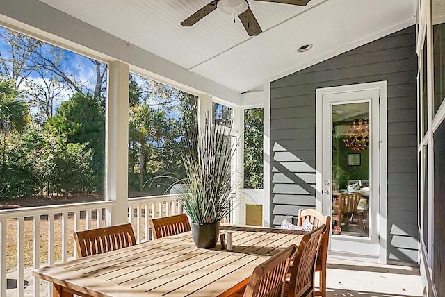 sunroom featuring a wealth of natural light, ceiling fan, and lofted ceiling