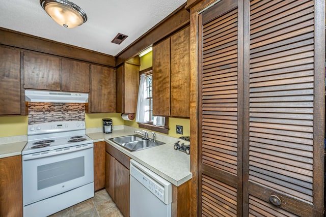 kitchen featuring white appliances and sink