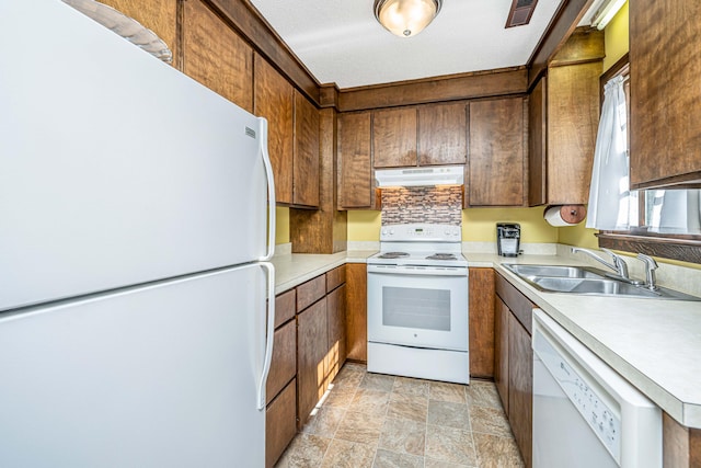 kitchen featuring white appliances, a textured ceiling, and sink