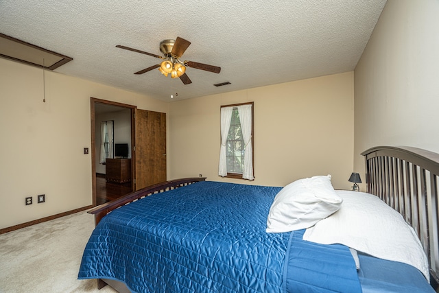 bedroom featuring ceiling fan, carpet floors, and a textured ceiling