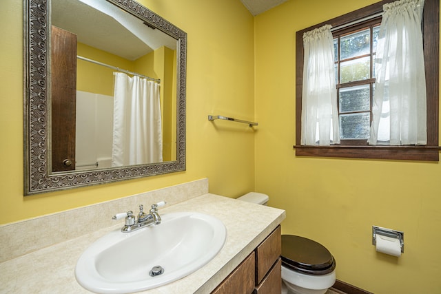 bathroom with vanity and toilet