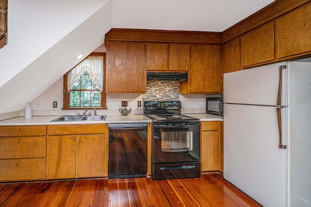 kitchen with dark wood-type flooring, backsplash, sink, and black appliances