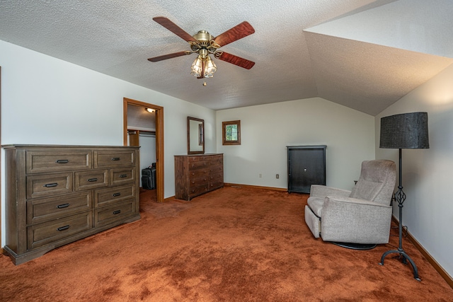 sitting room with lofted ceiling, ceiling fan, carpet floors, and a textured ceiling