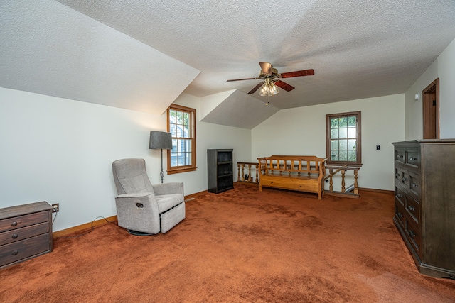 bedroom with carpet floors, a textured ceiling, vaulted ceiling, and ceiling fan