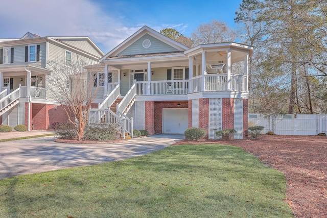 view of front of house with a garage, a front lawn, and covered porch