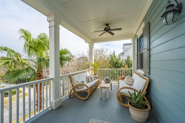 balcony with an outdoor living space and ceiling fan