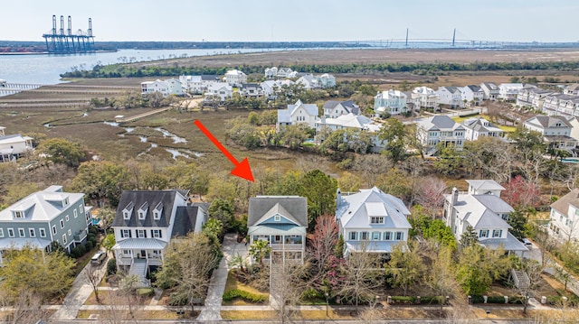 drone / aerial view with a residential view and a water view