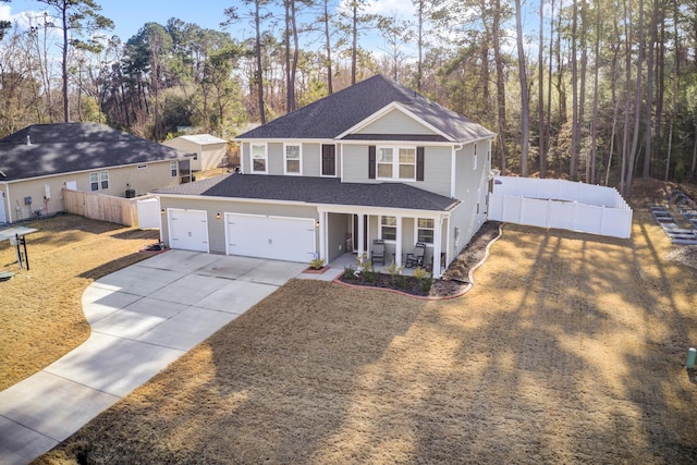 front facade featuring a garage, covered porch, and a front lawn