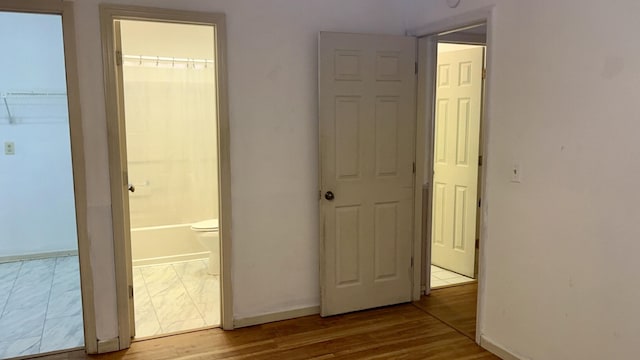 corridor with light hardwood / wood-style flooring