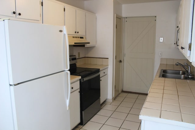 kitchen featuring white cabinetry, sink, white refrigerator, tile countertops, and black / electric stove