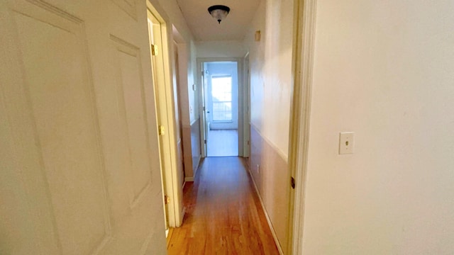 hall with light hardwood / wood-style flooring