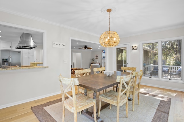 dining area featuring a notable chandelier, light wood-style flooring, and crown molding