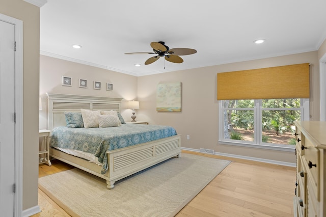 bedroom featuring visible vents, baseboards, ornamental molding, recessed lighting, and light wood-style floors