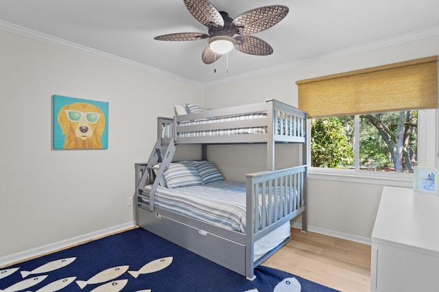 bedroom featuring baseboards, a ceiling fan, wood finished floors, and crown molding