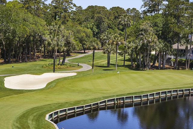 surrounding community featuring a yard, a water view, and golf course view