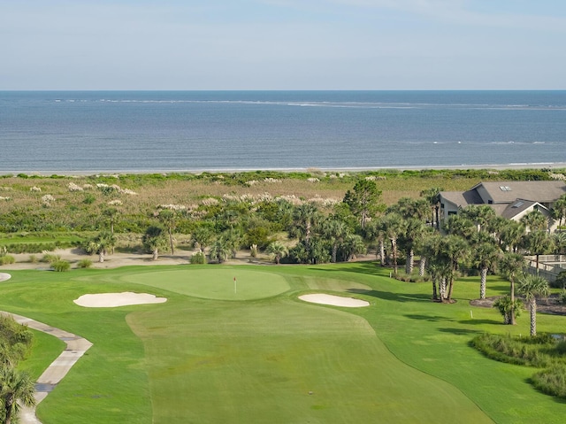 view of property's community with golf course view and a water view