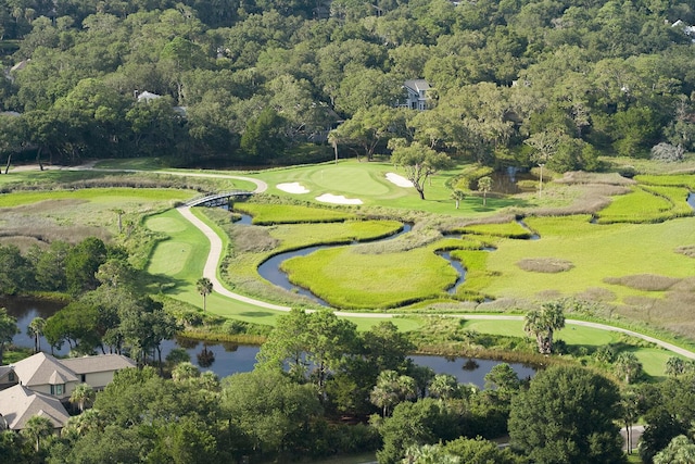 birds eye view of property featuring view of golf course and a water view