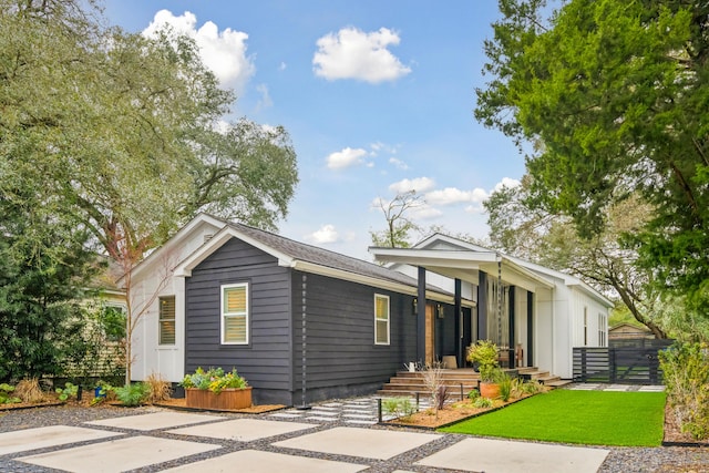 view of front of property with fence and a front lawn