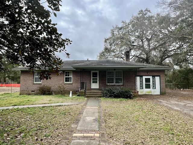 view of front of property featuring a porch, brick siding, a shingled roof, crawl space, and a front lawn