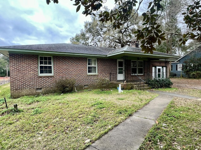 single story home with a front yard, crawl space, and brick siding