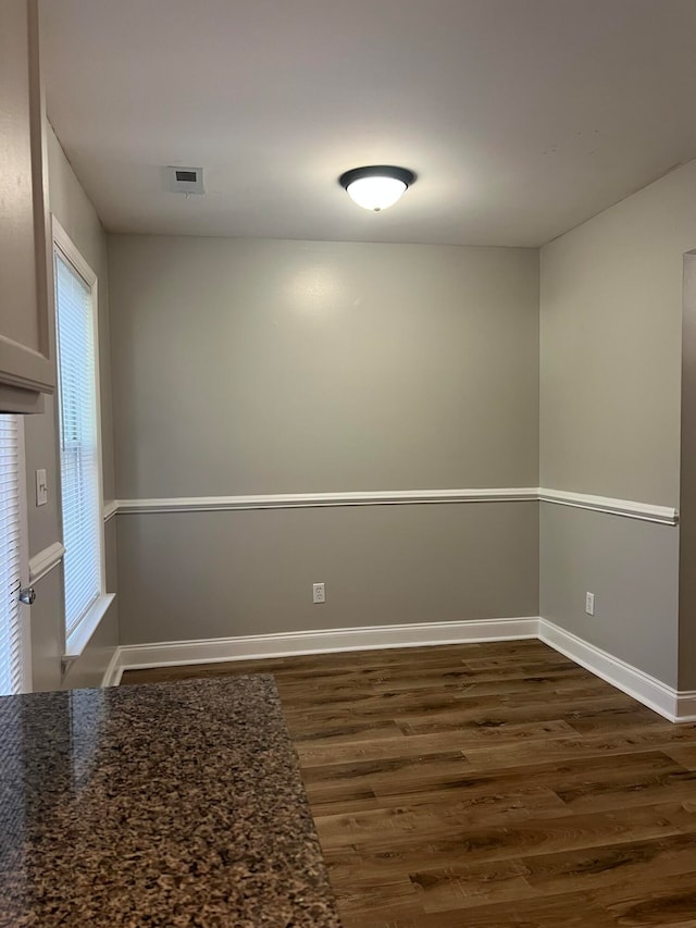 spare room with dark wood-type flooring