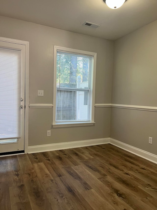 unfurnished room featuring dark wood-type flooring