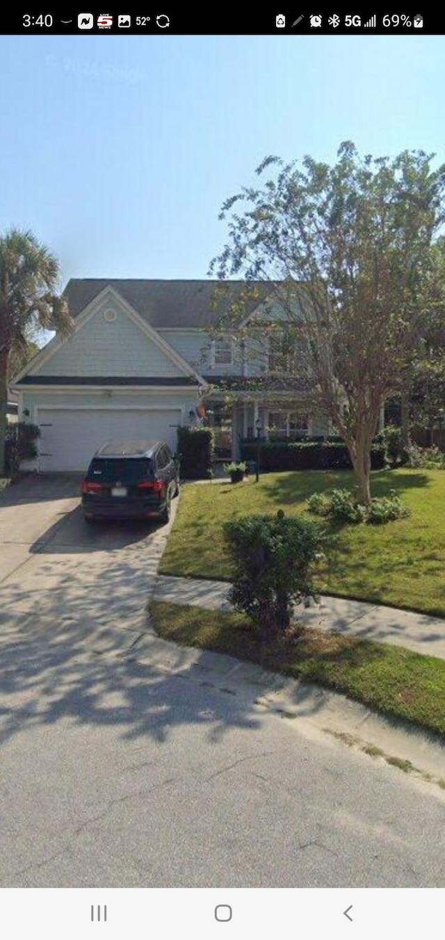 view of front of home featuring a garage and a front lawn