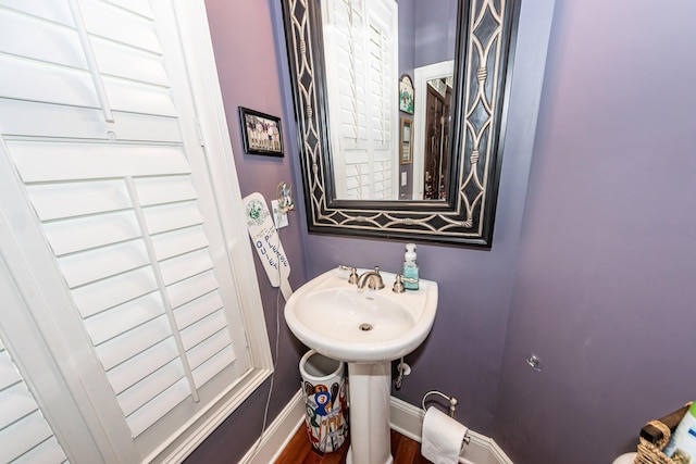 bathroom featuring baseboards and wood finished floors