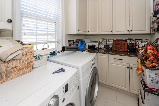 laundry room with separate washer and dryer, cabinet space, and light tile patterned flooring