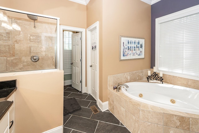 full bathroom with a jetted tub, tile patterned floors, crown molding, and a tile shower