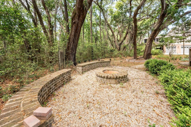 view of yard with a fire pit