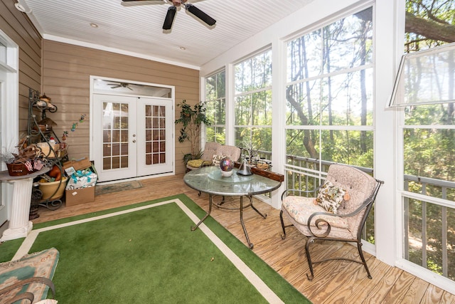 sunroom / solarium with a ceiling fan and french doors