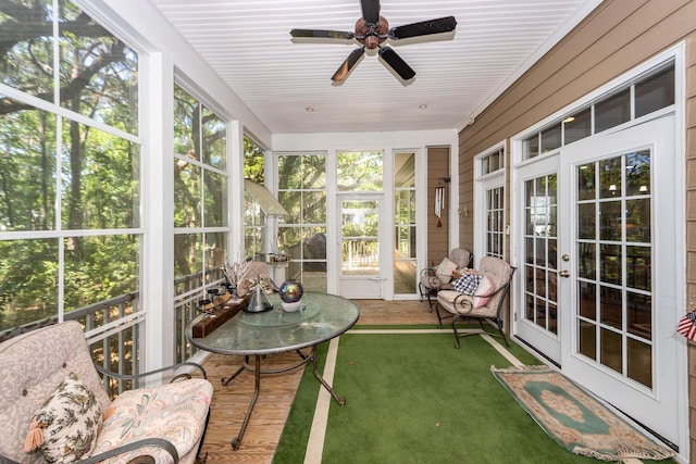sunroom / solarium featuring a ceiling fan and french doors