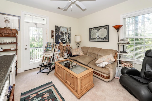 living room featuring ceiling fan, light carpet, and visible vents