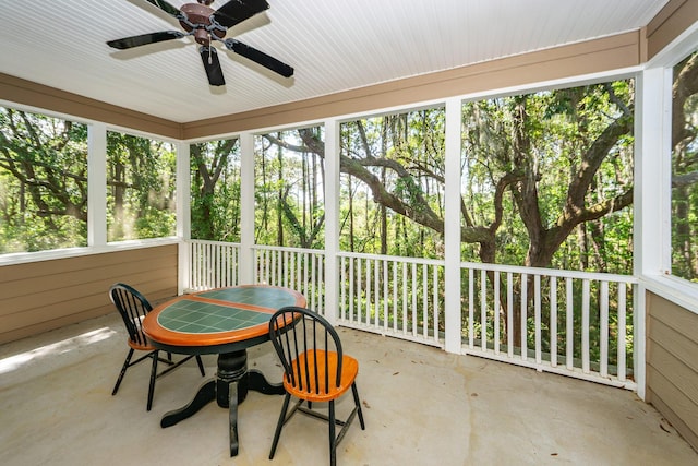 sunroom / solarium featuring ceiling fan