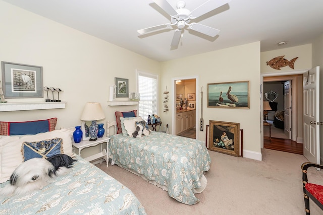 carpeted bedroom with baseboards, a ceiling fan, and connected bathroom